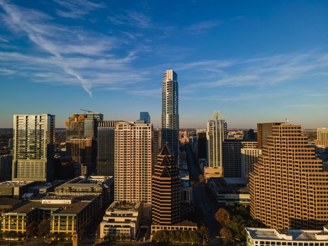 a drone image showing downtown Austin looking down congress street towards the capitol