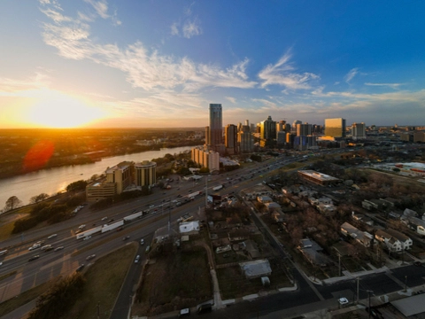 an aerial image showing downtown austin from the east at sunset